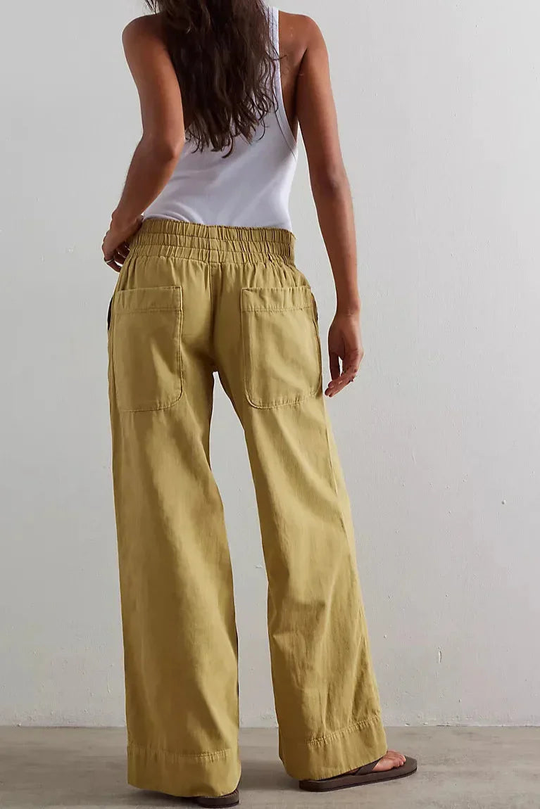 Blue denim wide-leg women's jeans by Christine Brewer, relaxed fit pants with a trendy, flowy silhouette.