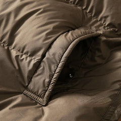 Long hooded parka for women by Christine Brewer, featuring a stylish design and adjustable hood in a cozy, weather-resistant fabric.