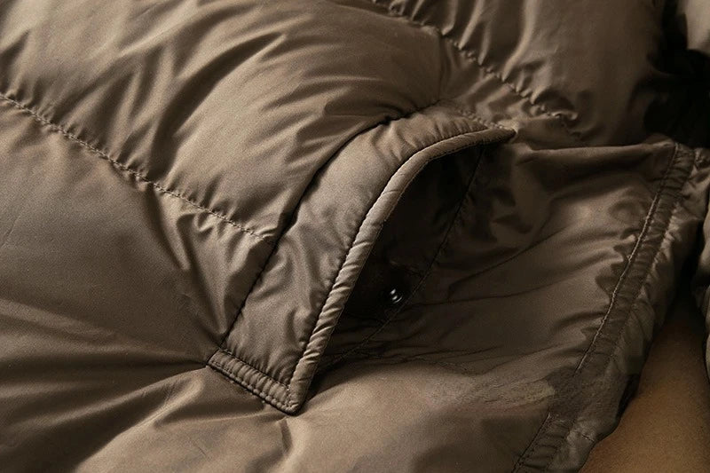Long hooded parka for women by Christine Brewer, featuring a stylish design and adjustable hood in a cozy, weather-resistant fabric.