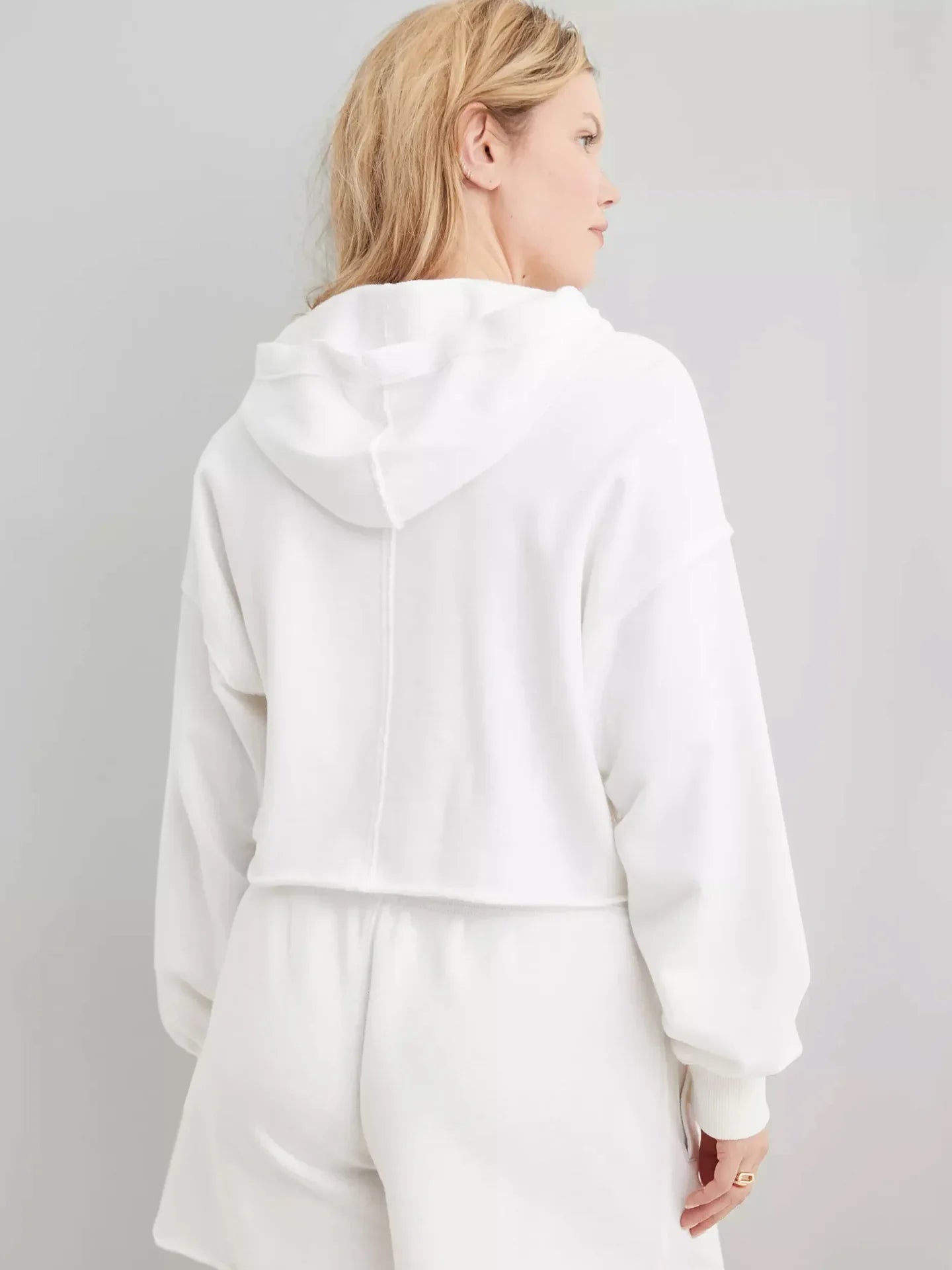 Eleanor cropped hoodie for women by Christine Brewer, shown in a casual fit with long sleeves and a soft fabric texture.