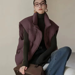 Layla cropped puffer vest for women by Christine Brewer, shown in black with quilted design and stand collar.