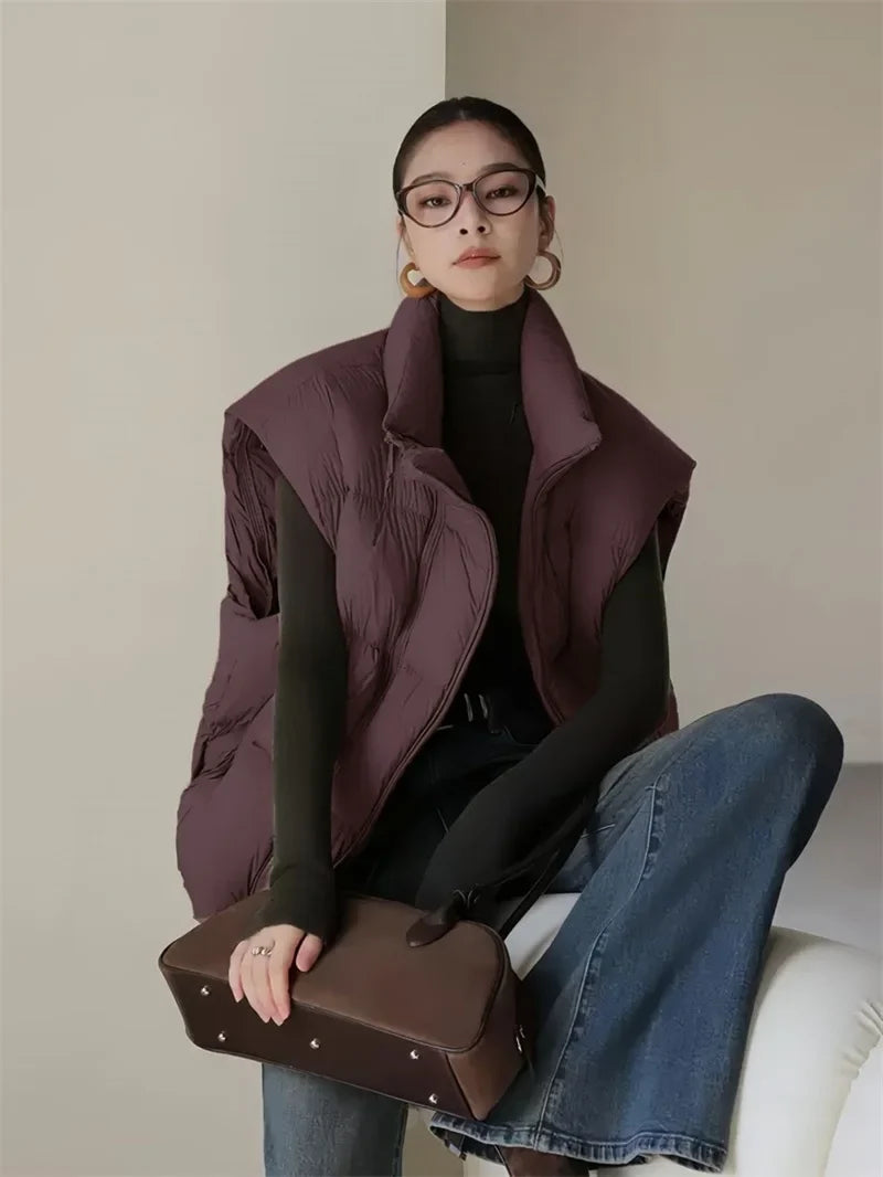 Layla cropped puffer vest for women by Christine Brewer, shown in black with quilted design and stand collar.