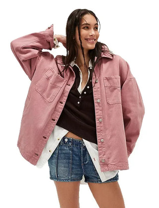 Oversized denim shirt jacket for women by Christine Brewer, featuring a classic blue denim design with long sleeves and button front.