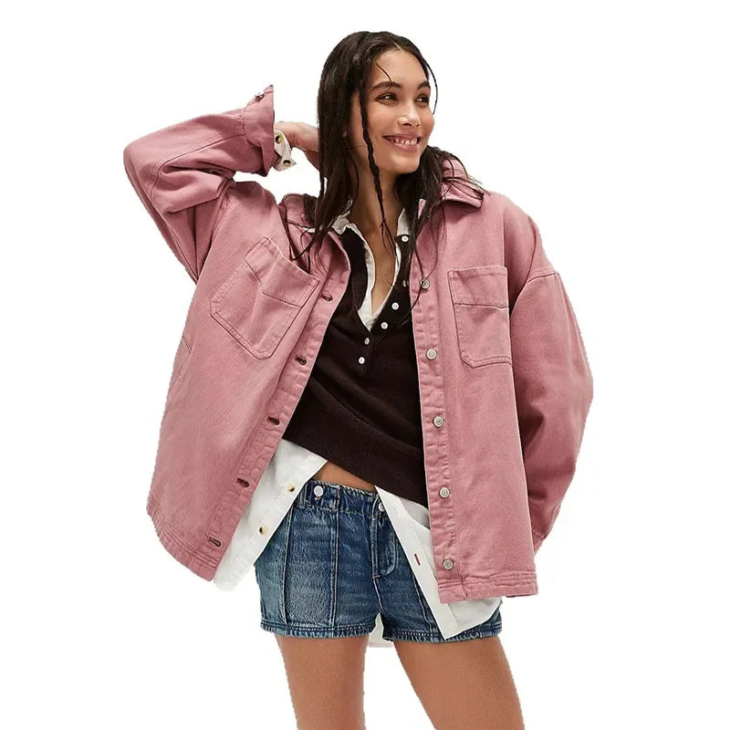 Oversized denim shirt jacket for women by Christine Brewer, featuring a classic blue denim design with long sleeves and button front.