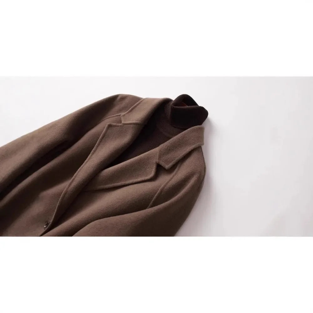 Brown double-breasted wool coat for women by Christine Brewer, stylish and warm outerwear with classic design details.