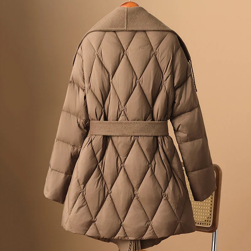 Women's Stella belted quilted puffer jacket by Christine Brewer, showcasing a warm, stylish quilted jacket with belt detail.