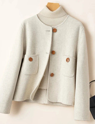 Elegant wool coat for women by Christine Brewer, featuring a tailored fit and classic design in a neutral color.