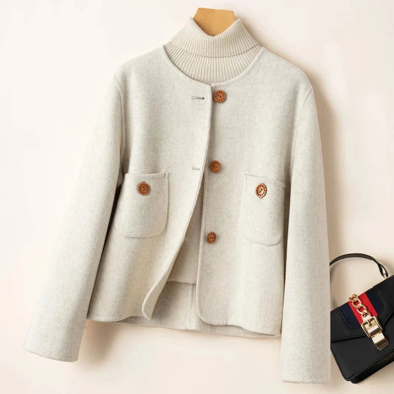 Elegant wool coat for women by Christine Brewer, featuring a tailored fit and classic design in a neutral color.