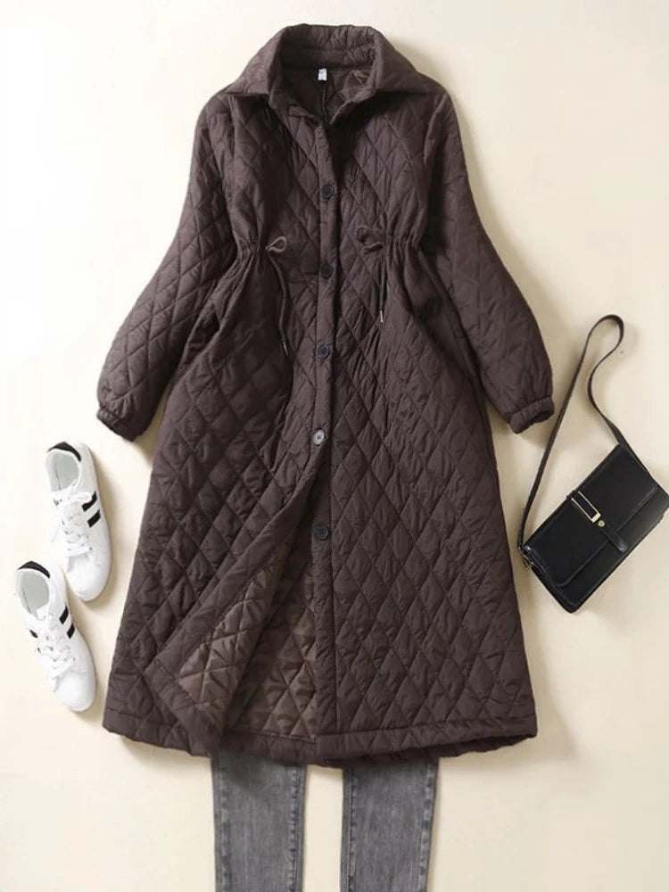 Longline puffer jacket for women by Christine Brewer, featuring a sleek design and quilted insulation for warmth and style.