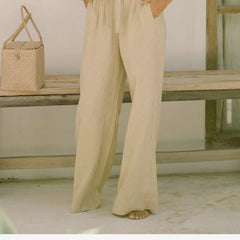 Light beige linen wide-leg trousers for women by Christine Brewer, featuring a loose pull-on style and relaxed fit.