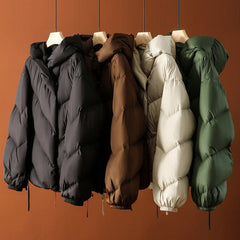 Women's cropped puffer jacket with hood by Christine Brewer, featuring quilted design and lightweight insulation.
