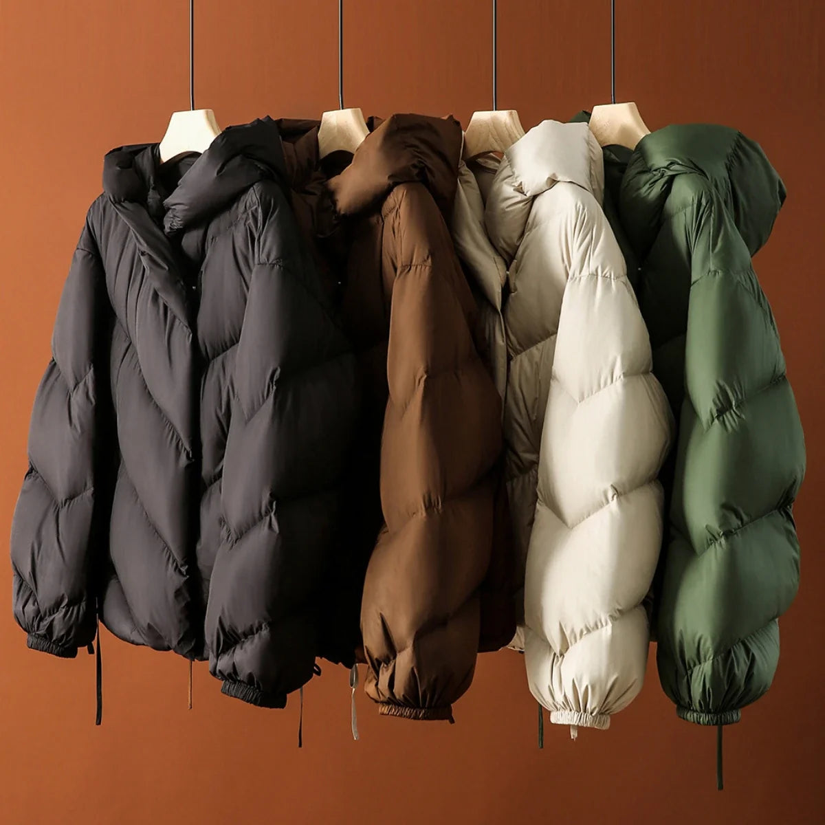 Women's cropped puffer jacket with hood by Christine Brewer, featuring quilted design and lightweight insulation.