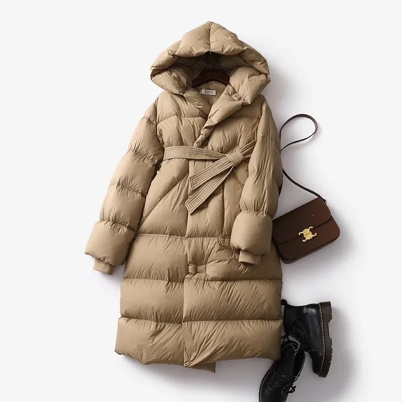 Ella long belted puffer jacket for women by Christine Brewer, shown in a stylish, quilted design with a belt at the waist.