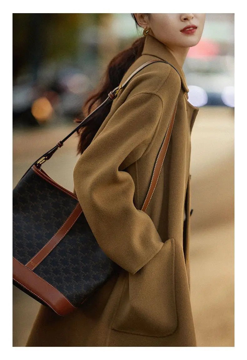 Green long wool coat for women from Christine Brewer, featuring a stylish and cozy design, displayed on a model.