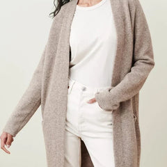 Woman wearing the Jacqueline merino wool cardigan for women by Christine Brewer, featuring a cozy, stylish knit design.