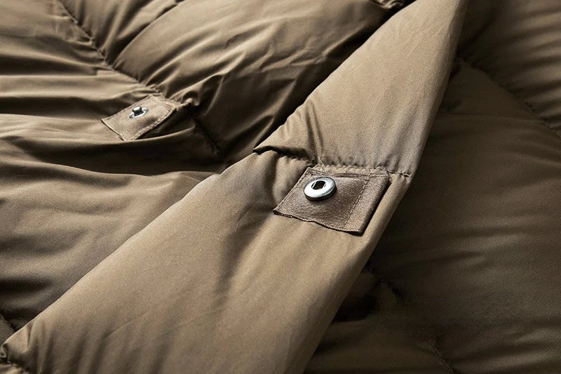 Long hooded women's parka from Christine Brewer's Ava collection, featuring a stylish design and cozy hood for cold weather.