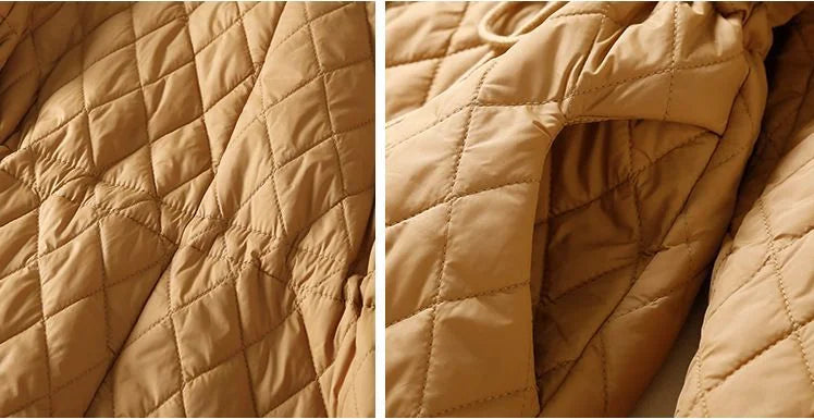 Longline puffer jacket for women by Christine Brewer, featuring a stylish, insulated design ideal for cold weather.