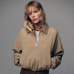 Violet zip-up puffer jacket for women by Christine Brewer, featuring a quilted design and cozy collar.