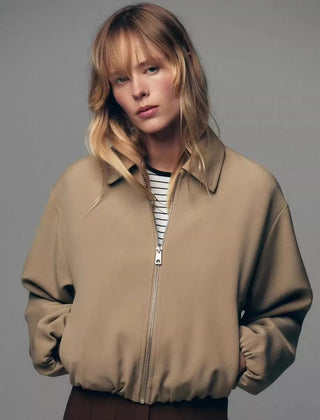 Violet zip-up puffer jacket for women by Christine Brewer, featuring a quilted design and cozy collar.