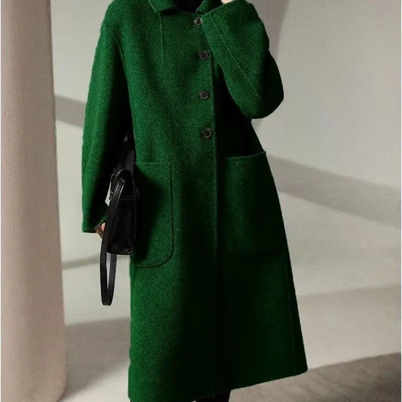 Green long wool coat for women by Christine Brewer, featuring a stylish, tailored design with lapels and button closure.