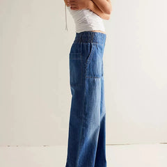 Blue denim wide-leg women's jeans by Christine Brewer featuring relaxed fit and classic denim style.