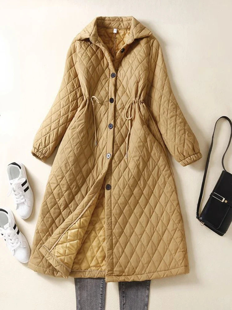 Longline puffer jacket for women by Christine Brewer, featuring a warm, quilted design with a high collar and stylish length.