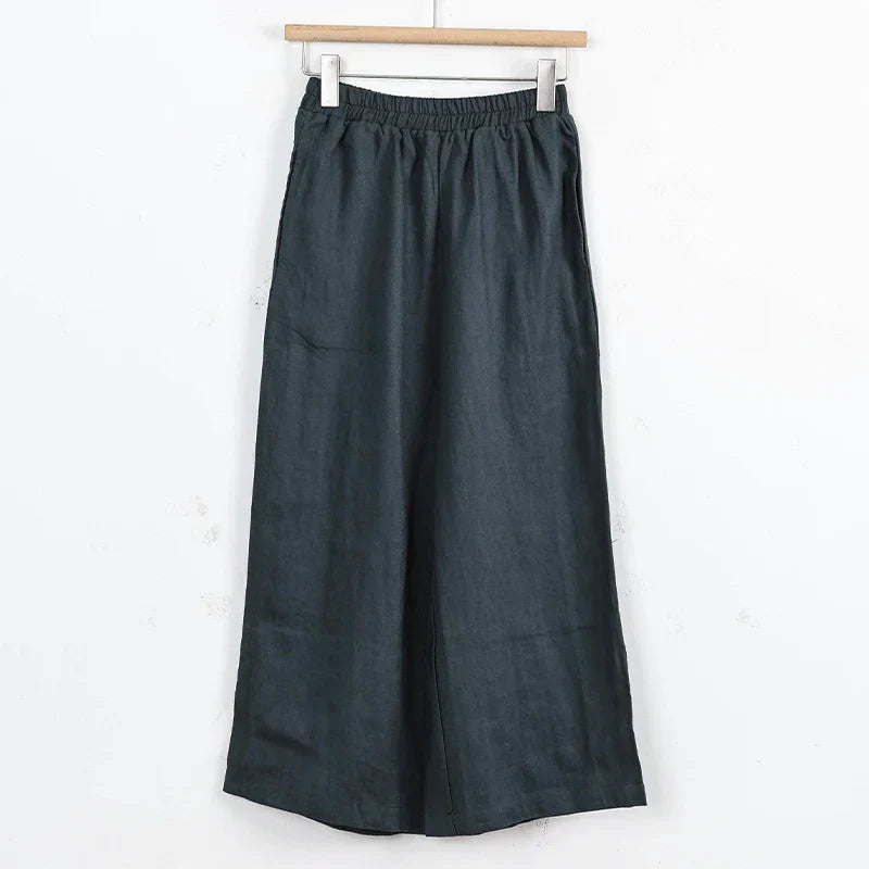 Light beige linen cropped wide-leg drawstring trousers for women with a loose fit, designed by Christine Brewer.