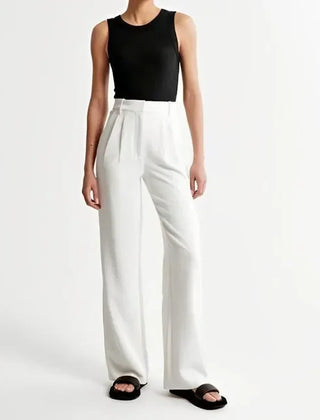 White wide-leg high-waist trousers for women by Christine Brewer, featuring a stylish high-waist design and relaxed fit.