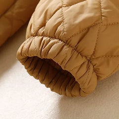 Christine Brewer Elena longline puffer jacket for women, showcasing its sleek, quilted design and cozy winter style.