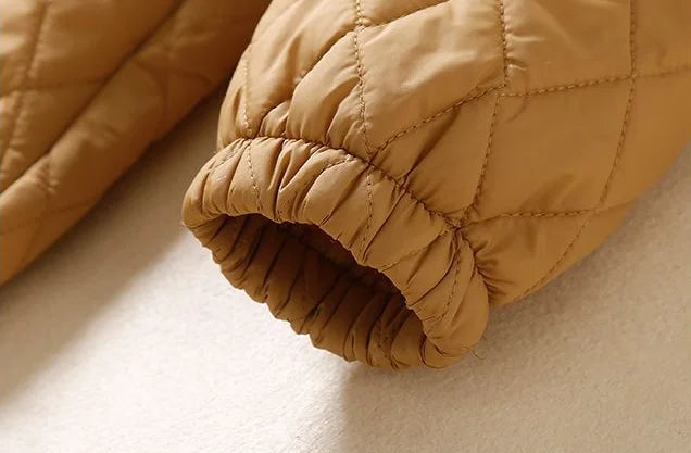 Christine Brewer Elena longline puffer jacket for women, showcasing its sleek, quilted design and cozy winter style.