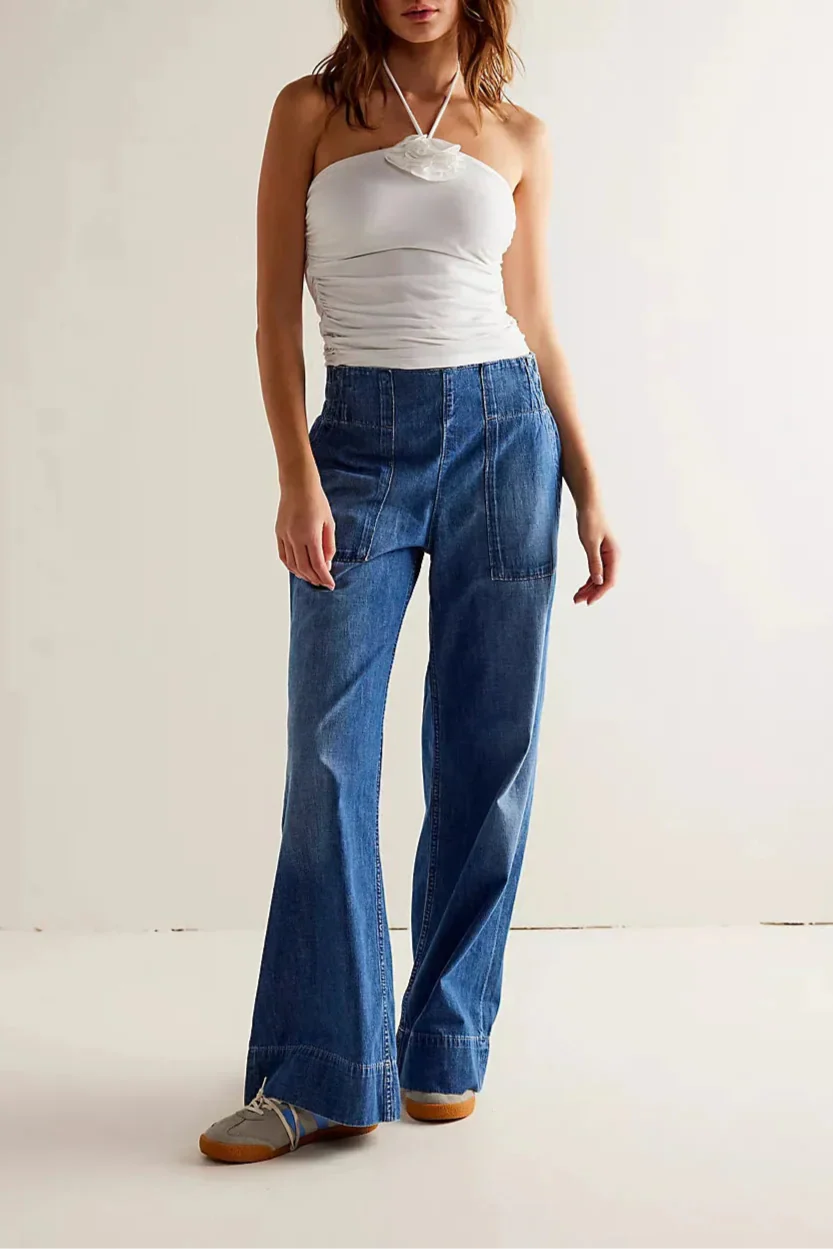 Blue denim wide-leg women's jeans by Christine Brewer, relaxed fit pants with a stylish casual look.