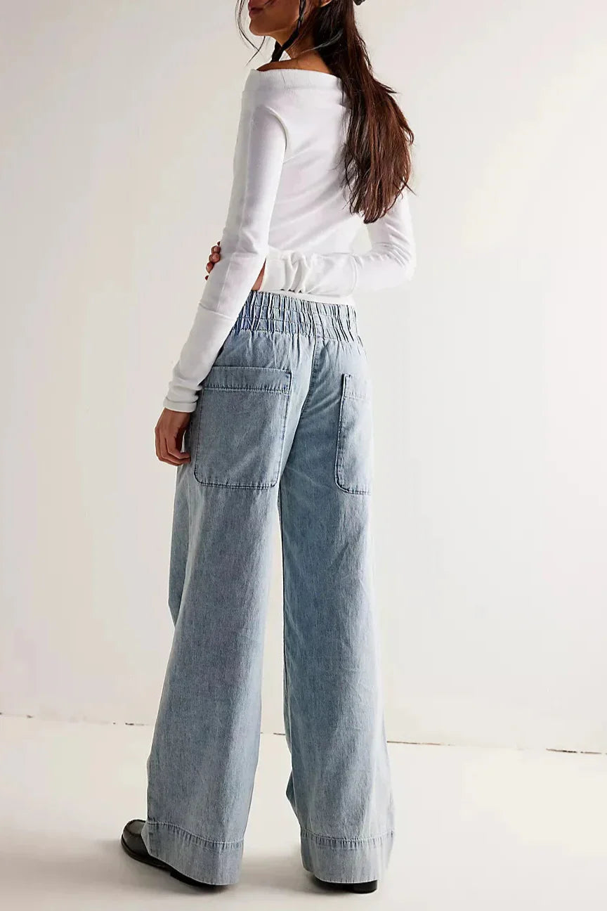 Blue denim wide-leg women's jeans by Christine Brewer, relaxed fit pants with a casual, stylish look.