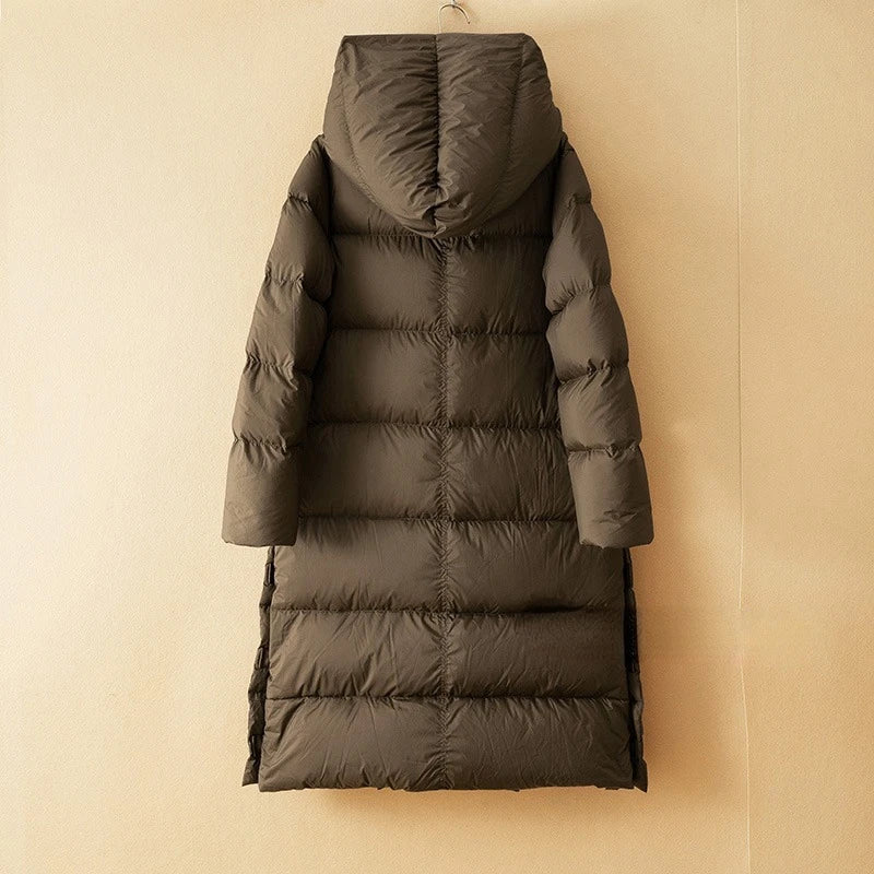 Long hooded parka for women by Christine Brewer, featuring a stylish design with a hood and secure pockets.
