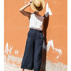 Light beige linen cropped wide-leg drawstring trousers for women by Christine Brewer, featuring a loose pull-on style.
