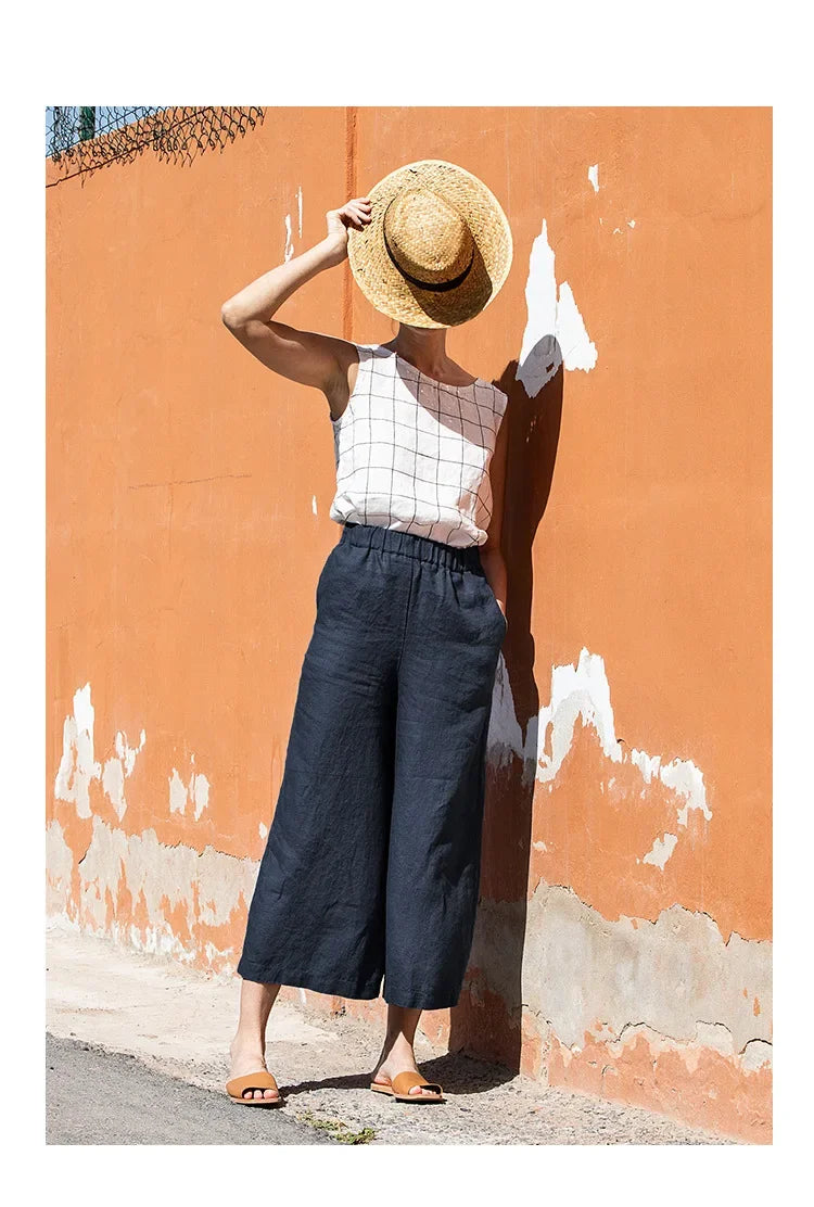 Light beige linen cropped wide-leg drawstring trousers for women by Christine Brewer, featuring a loose pull-on style.