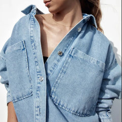 Nora relaxed denim shirt jacket for women by Christine Brewer, featuring classic blue denim with button closure and chest pockets.