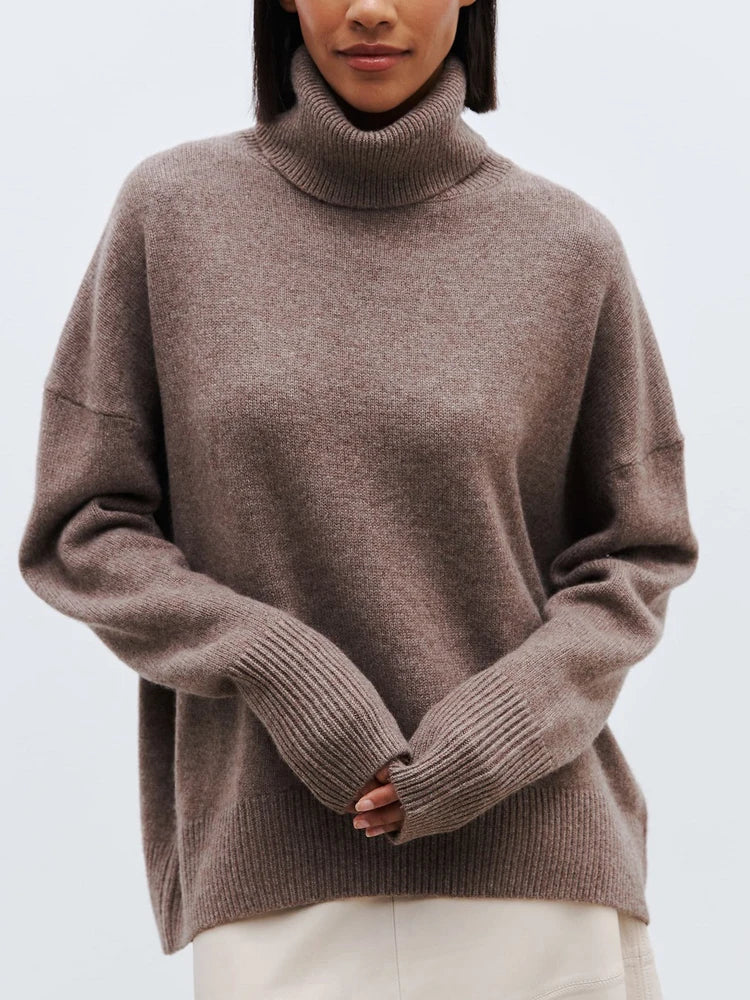 Cream-colored Erica oversized turtleneck sweater for women by Christine Brewer, featuring a cozy, relaxed fit and ribbed cuffs.