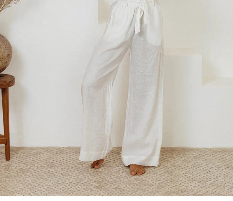 Light beige linen wide-leg trousers for women by Christine Brewer, featuring a loose pull-on style and relaxed fit.
