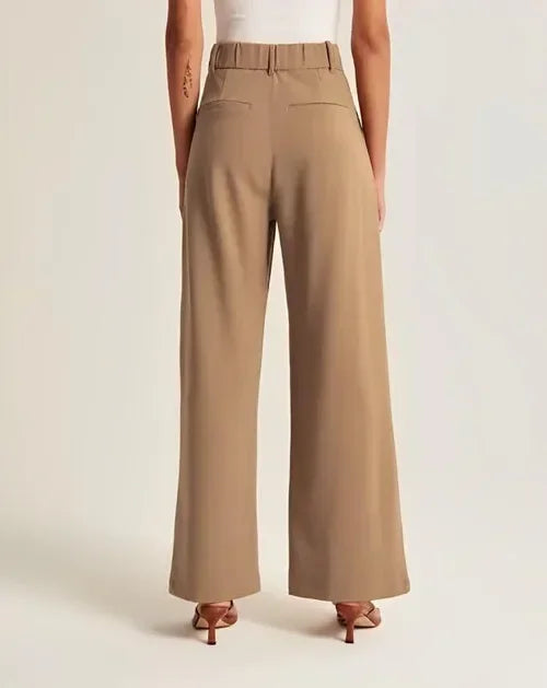 White wide-leg high-waist women's trousers by Christine Brewer, featuring a relaxed fit and tailored high-rise design.