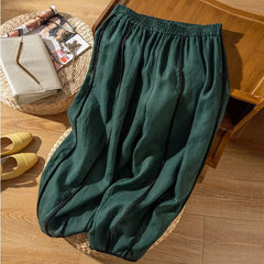 Women’s linen wide-leg elastic-waist trousers by Christine Brewer, loose pull-on pants with a relaxed fit and natural fabric look.