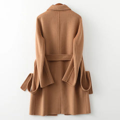Olivia long belted wool coat for women by Christine Brewer, shown in a stylish black design with a belt and classic collar.