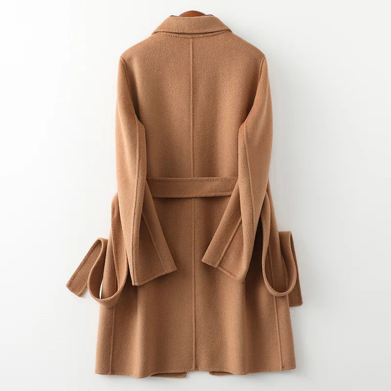Olivia long belted wool coat for women by Christine Brewer, shown in a stylish black design with a belt and classic collar.