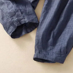 Light beige tapered linen trousers for women by Christine Brewer, featuring a loose pull-on style and relaxed fit.