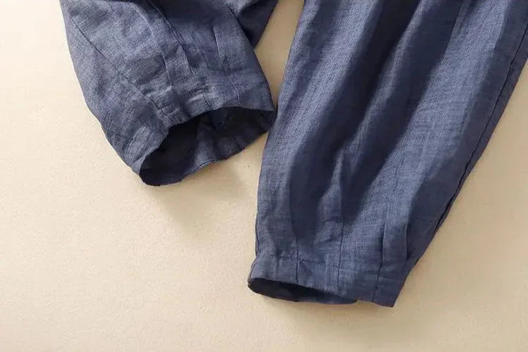 Light beige tapered linen trousers for women by Christine Brewer, featuring a loose pull-on style and relaxed fit.