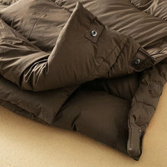 Long hooded parka for women by Christine Brewer, featuring a stylish design and a warm, cozy fit for cold weather.