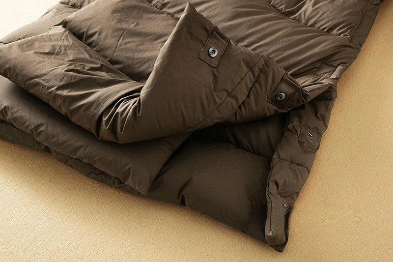 Long hooded parka for women by Christine Brewer, featuring a stylish design and a warm, cozy fit for cold weather.