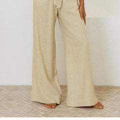 Light beige linen wide-leg trousers for women, loose pull-on style by Christine Brewer, with a relaxed fit and flowing fabric.