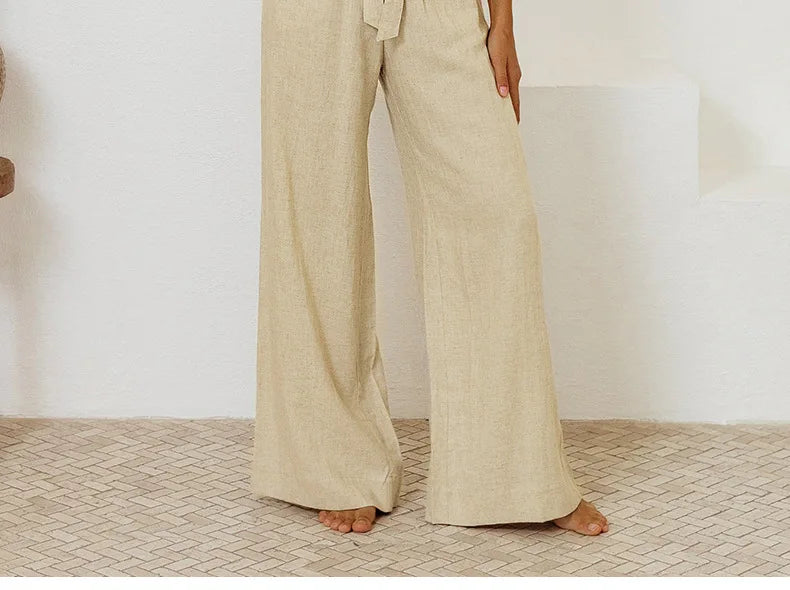 Light beige linen wide-leg trousers for women, loose pull-on style by Christine Brewer, with a relaxed fit and flowing fabric.