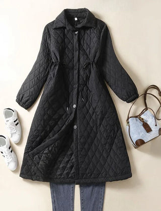 Longline black puffer jacket for women by Christine Brewer, featuring a warm, quilted design and a hooded style.