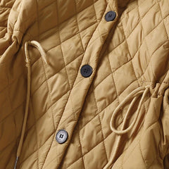Longline puffer jacket for women by Christine Brewer, featuring a warm, quilted design and hooded style for winter wear.